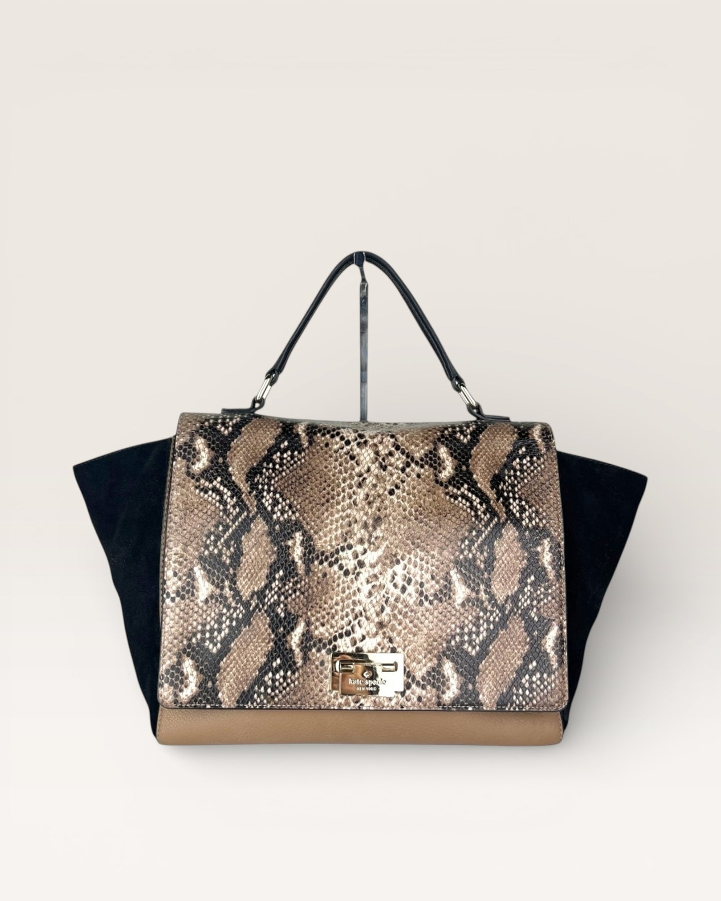 Snakeskin pattern handbag on a light gray background